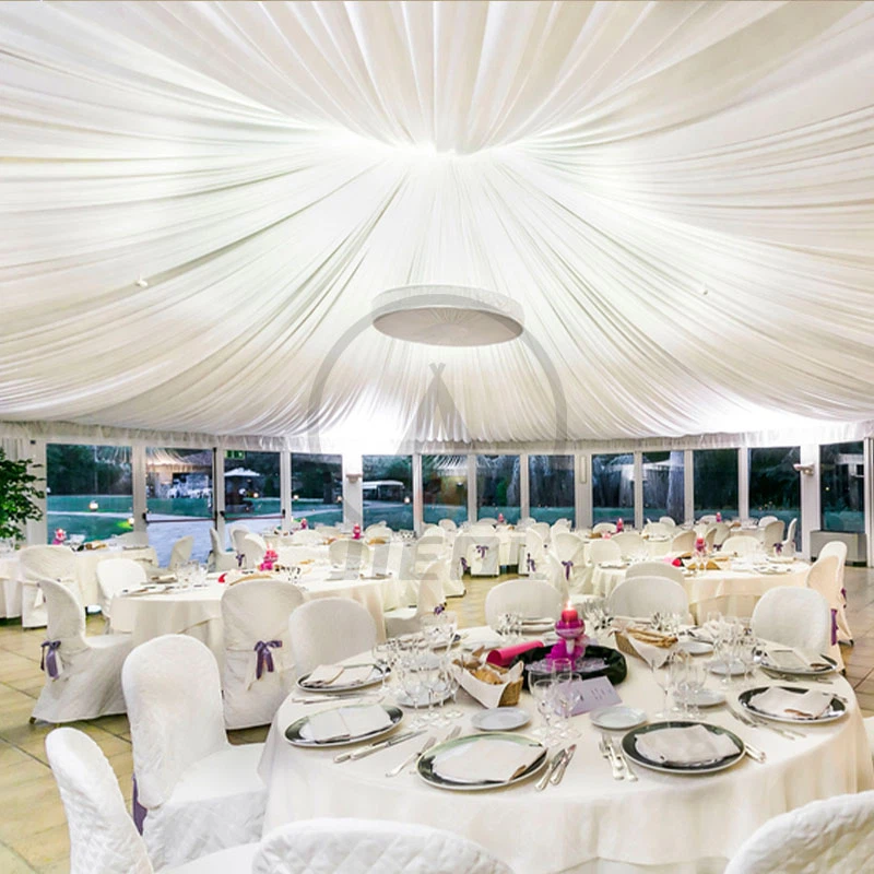 Outdoor wedding reception with draped ceilings and white decor Outdoor wedding reception with draped ceilings and white decor